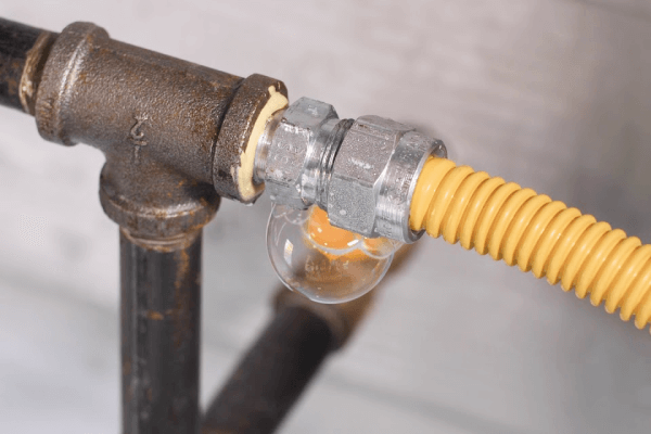 Gas leak bubbling at pipe joint, call Blue Diamond Plumbing for safe repairs