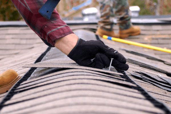 Roof repair plumber sealing metal roof seam to stop leaks and prevent damage