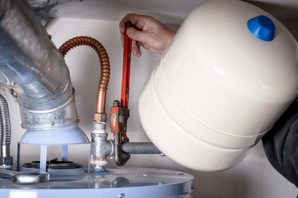 Plumber repairing hot water system to restore hot water fast and stop leaks