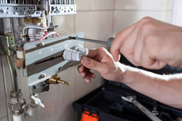 Plumber Fixing the heater controls