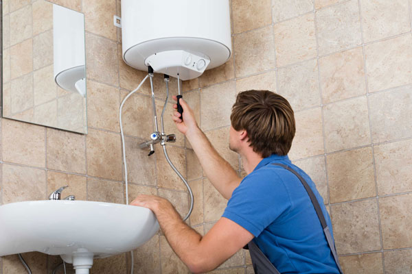 Plumber checking the heater wirings