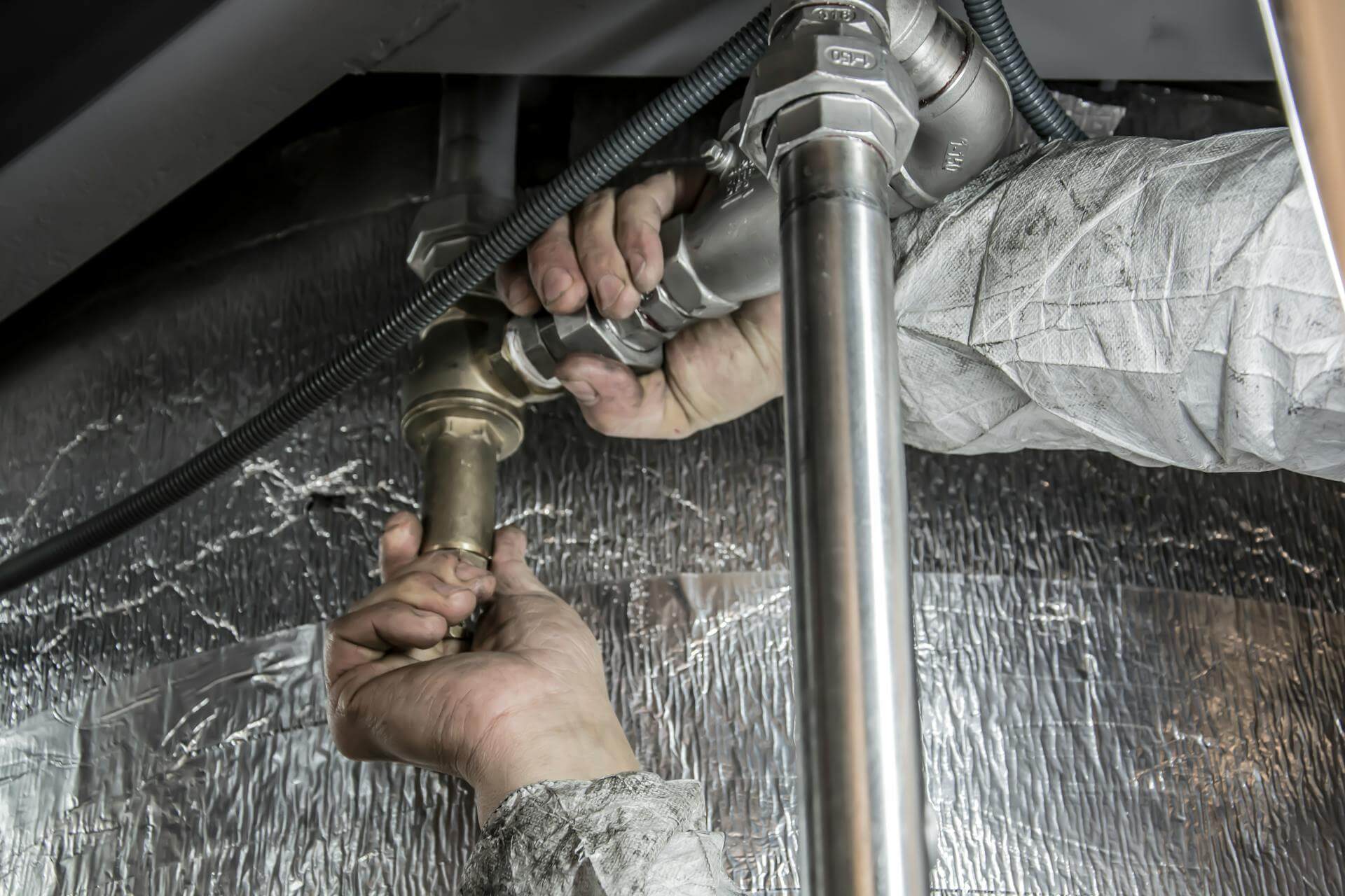 Plumber clearing blockage on the pipes