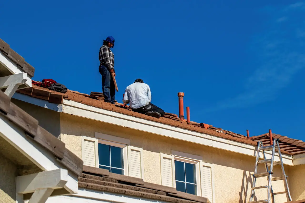 Maintenance people checking for roof leaks
