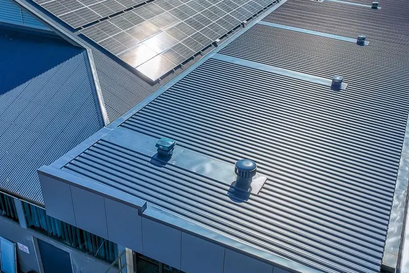 Metal roof with box gutters, rainheads, and drainage system installed